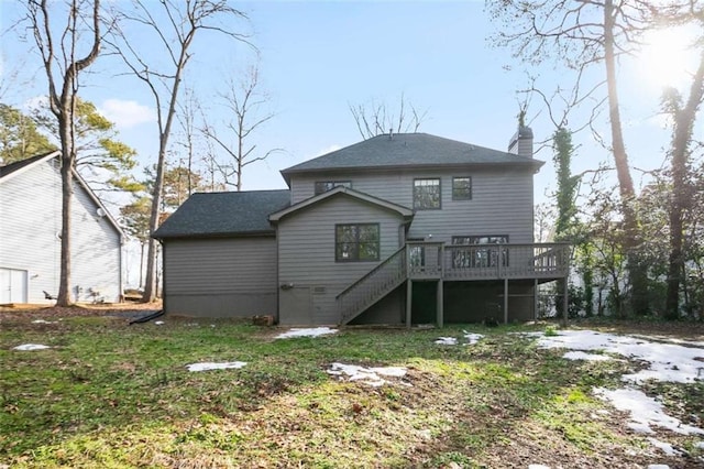 rear view of house with a deck and a yard