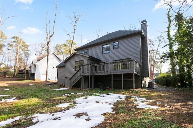 rear view of property featuring a deck and central AC unit