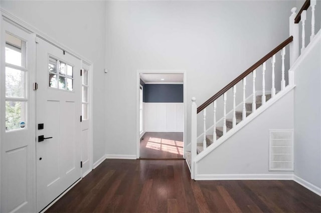 foyer with dark hardwood / wood-style floors and crown molding