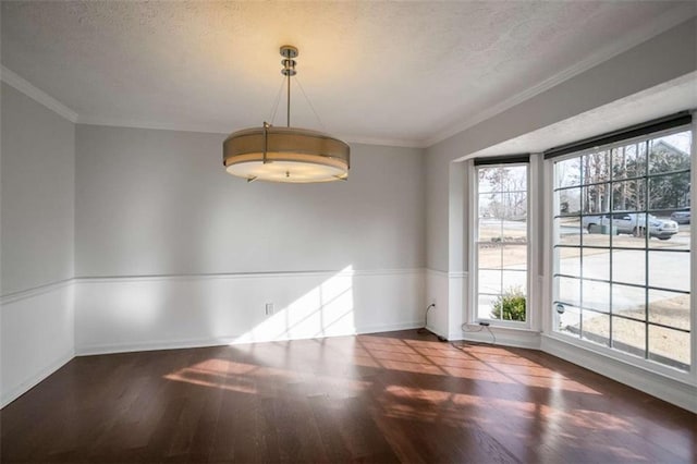 unfurnished dining area featuring ornamental molding and a textured ceiling