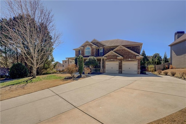 traditional home with concrete driveway, brick siding, and an attached garage