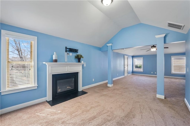 unfurnished living room featuring carpet, visible vents, a fireplace with flush hearth, vaulted ceiling, and baseboards