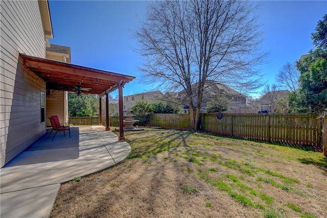 view of yard with a patio, a fenced backyard, and a ceiling fan