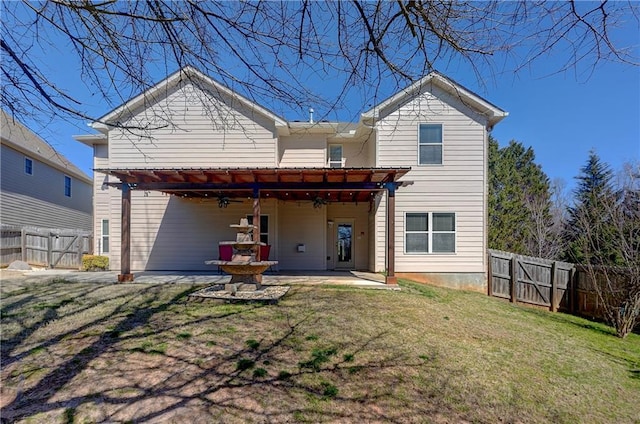 rear view of house with fence private yard, a gate, a patio area, and a yard