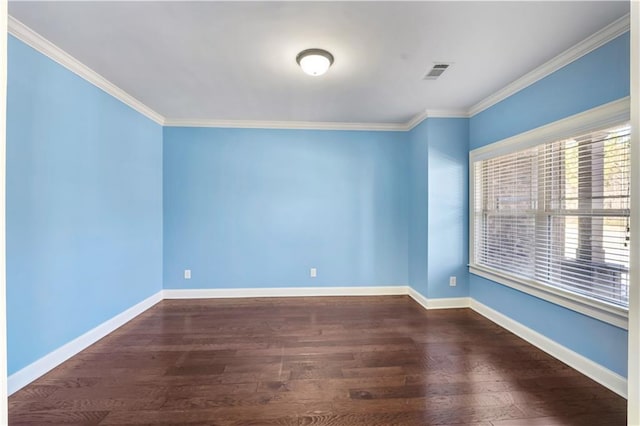 unfurnished room with baseboards, visible vents, and wood finished floors