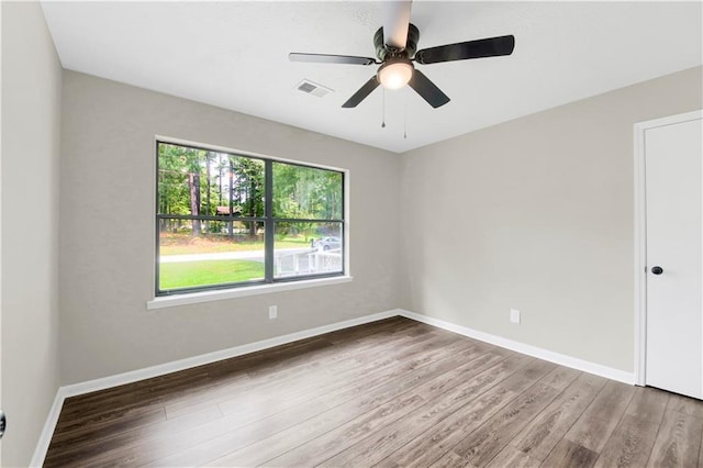 558 Newlin Ct, Lawrenceville, GA 30046 - empty room with wood finished floors and a ceiling fan