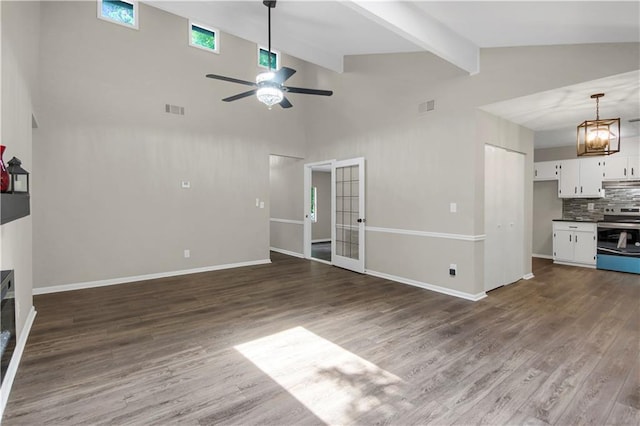 558 Newlin Ct, Lawrenceville, GA 30046 - unfurnished living room with a ceiling fan, beam ceiling, dark wood finished floors, high vaulted ceiling, and a chandelier