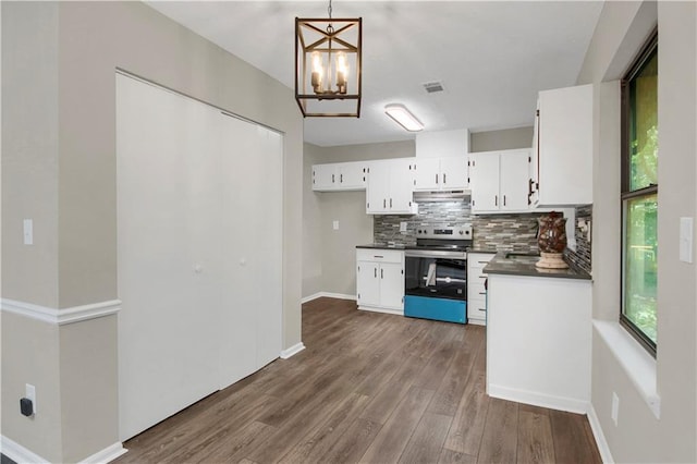 558 Newlin Ct, Lawrenceville, GA 30046 - kitchen with stainless steel range with electric stovetop, dark countertops, tasteful backsplash, white cabinetry, and a chandelier
