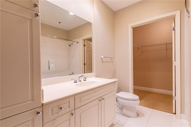 bathroom featuring toilet, vanity, tile patterned flooring, and walk in shower