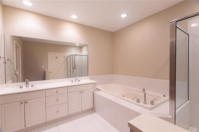 bathroom with tile patterned flooring, vanity, and separate shower and tub