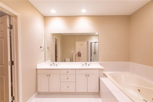 bathroom featuring tile patterned flooring, vanity, and plus walk in shower