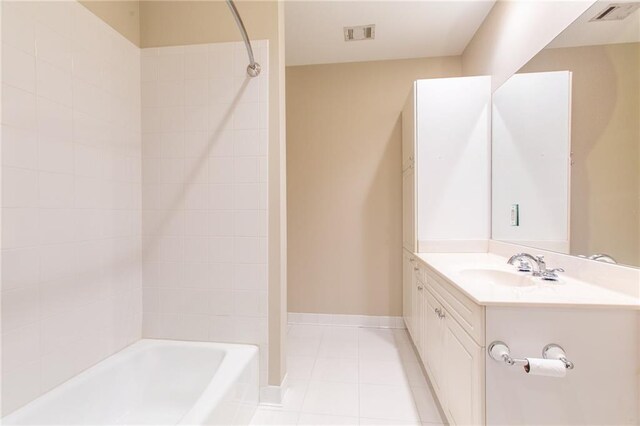 bathroom with vanity, tile patterned floors, and tiled shower / bath