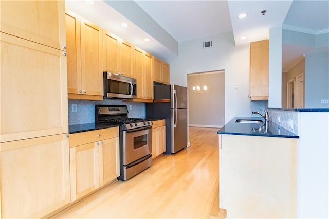 kitchen featuring stainless steel appliances, light hardwood / wood-style floors, sink, light brown cabinetry, and backsplash