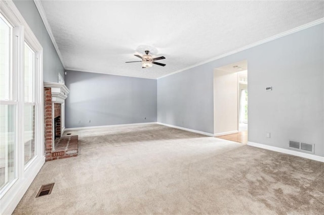 65 Millennial Ct, Lawrenceville, GA 30045 - unfurnished living room with carpet floors, ceiling fan, baseboards, crown molding, and a fireplace