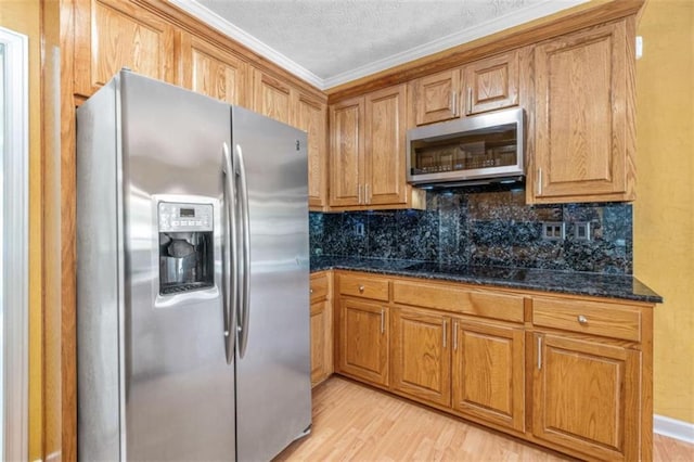 65 Millennial Ct, Lawrenceville, GA 30045 - kitchen featuring appliances with stainless steel finishes, tasteful backsplash, crown molding, light wood-style flooring, and a textured ceiling