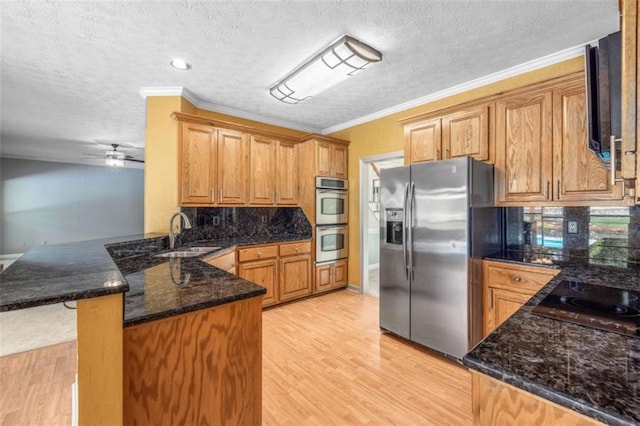 65 Millennial Ct, Lawrenceville, GA 30045 - kitchen with a sink, appliances with stainless steel finishes, a peninsula, light wood-style floors, and ornamental molding