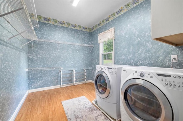 65 Millennial Ct, Lawrenceville, GA 30045 - laundry room featuring washing machine and dryer, wood finished floors, wallpapered walls, and baseboards