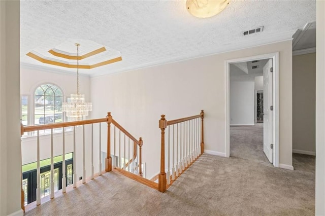 65 Millennial Ct, Lawrenceville, GA 30045 - hall featuring an upstairs landing, a chandelier, carpet floors, crown molding, and a textured ceiling