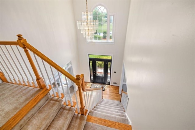 65 Millennial Ct, Lawrenceville, GA 30045 - carpeted entryway featuring a chandelier, stairway, a high ceiling, and baseboards