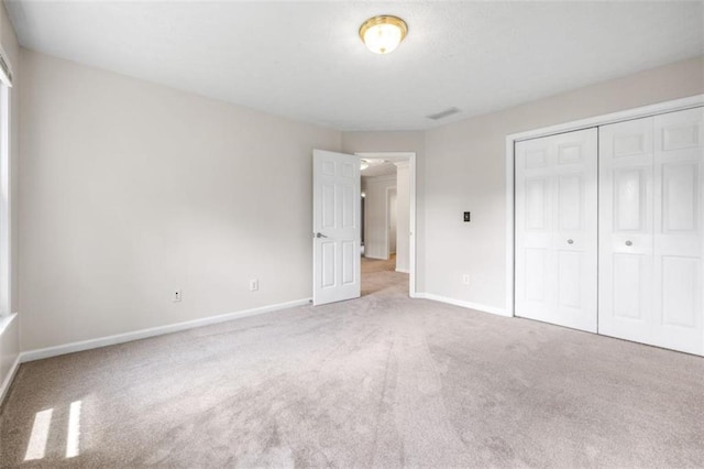 65 Millennial Ct, Lawrenceville, GA 30045 - unfurnished bedroom featuring baseboards, carpet floors, and a closet