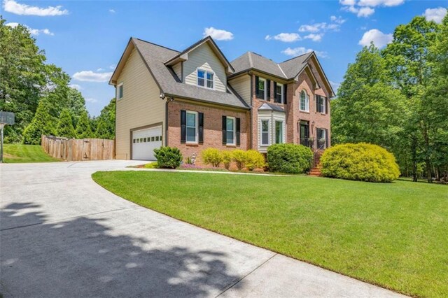 65 Millennial Ct, Lawrenceville, GA 30045 - view of front of property featuring a garage, concrete driveway, and brick siding