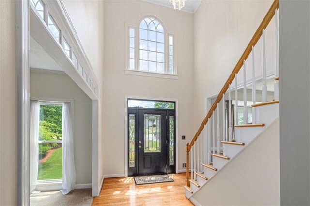 65 Millennial Ct, Lawrenceville, GA 30045 - foyer entrance with stairway, wood finished floors, a high ceiling, ornamental molding, and baseboards