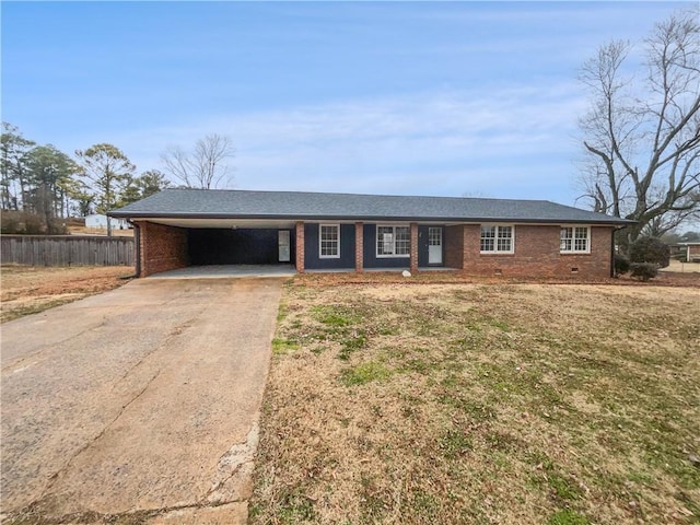 ranch-style home featuring a carport and a front lawn