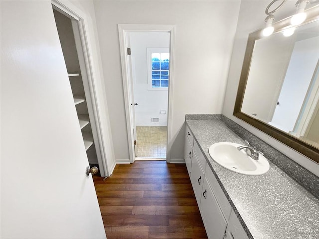 bathroom with vanity and hardwood / wood-style flooring