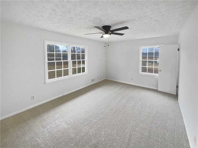 spare room with ceiling fan, carpet floors, and a textured ceiling