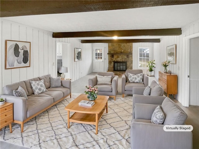 living room featuring a fireplace and beamed ceiling