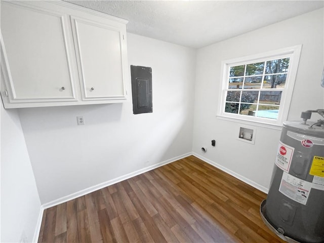 laundry area with dark wood-type flooring, electric panel, electric water heater, cabinets, and washer hookup