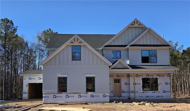 view of front of house with board and batten siding and roof with shingles