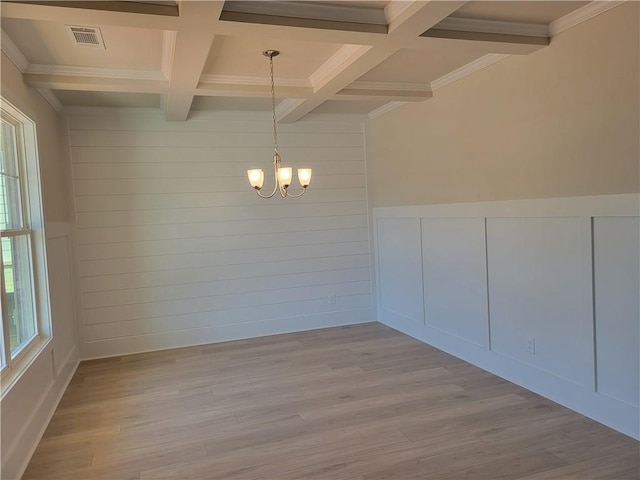 unfurnished room featuring a chandelier, light wood-type flooring, beam ceiling, and coffered ceiling