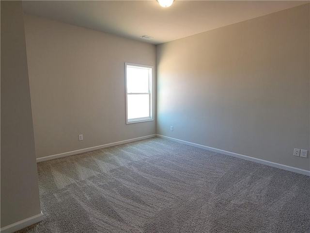 spare room with carpet and baseboards