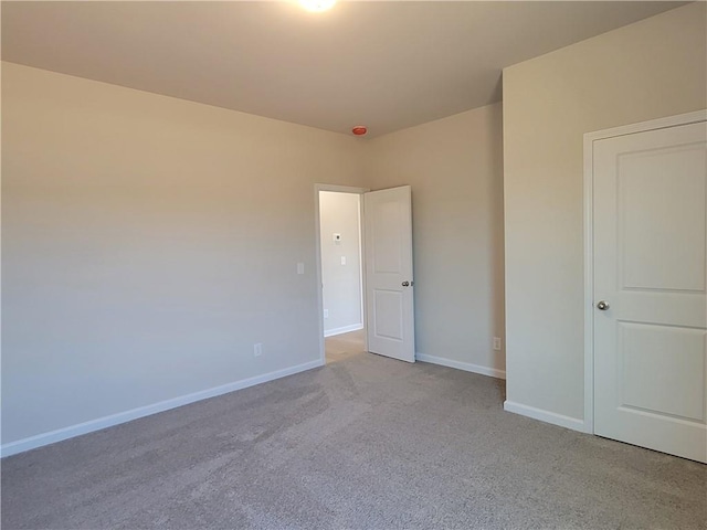 unfurnished bedroom with carpet floors and baseboards