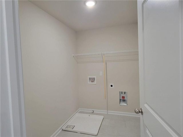 washroom featuring laundry area, baseboards, tile patterned floors, hookup for a washing machine, and hookup for an electric dryer