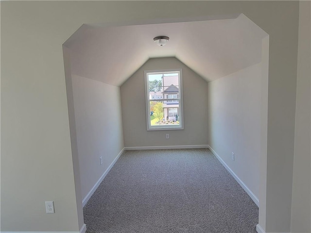 bonus room featuring lofted ceiling, carpet floors, and baseboards