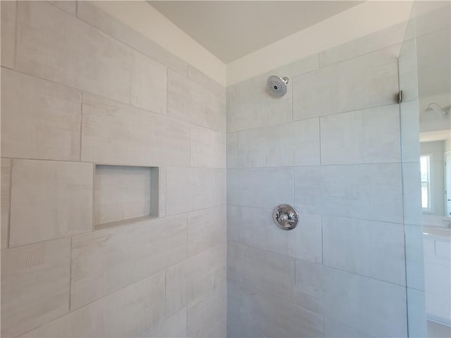 bathroom with tiled shower