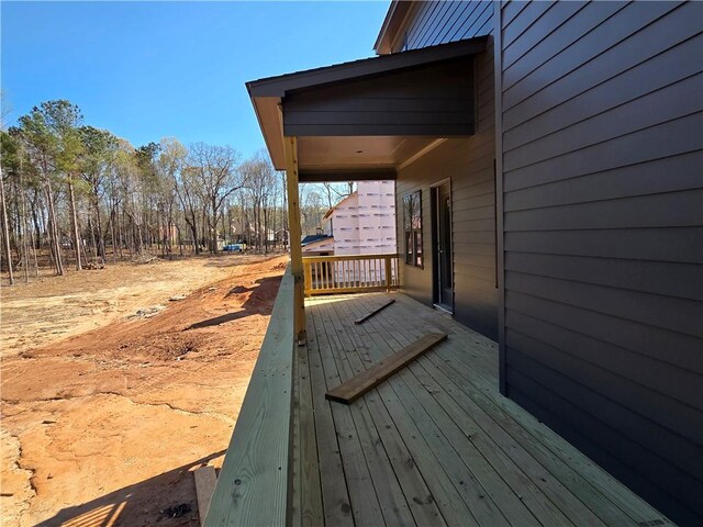 wooden terrace with a view of trees