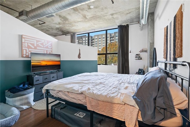 bedroom with hardwood / wood-style flooring