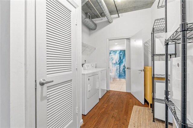 washroom featuring dark hardwood / wood-style floors and independent washer and dryer