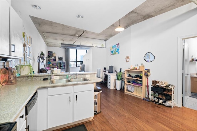 kitchen featuring white cabinetry, sink, black stove, kitchen peninsula, and light hardwood / wood-style floors