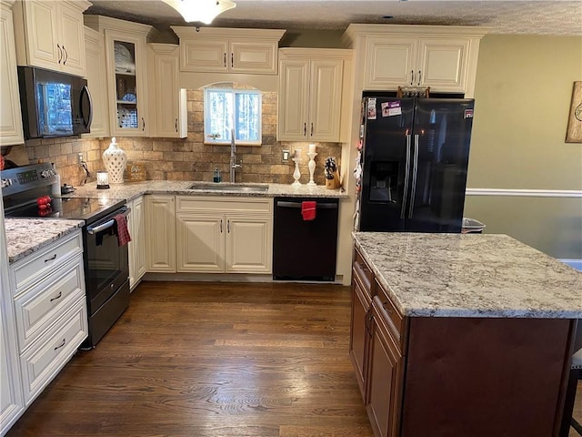 kitchen with white cabinetry, dark hardwood / wood-style flooring, sink, and black appliances