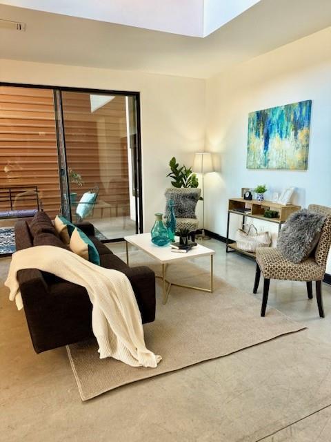 living area with finished concrete floors and visible vents