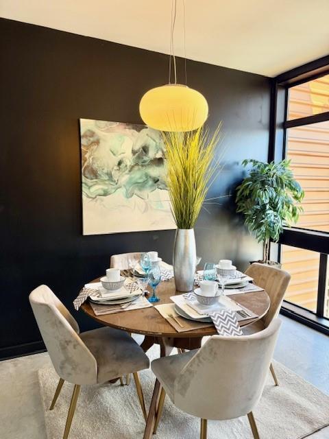 dining area featuring concrete floors