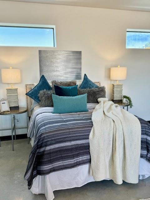 bedroom featuring concrete floors and baseboard heating