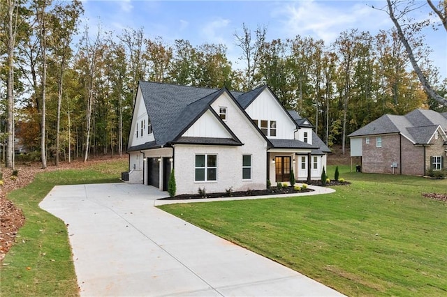 modern farmhouse style home featuring a garage, a shingled roof, concrete driveway, a front lawn, and board and batten siding