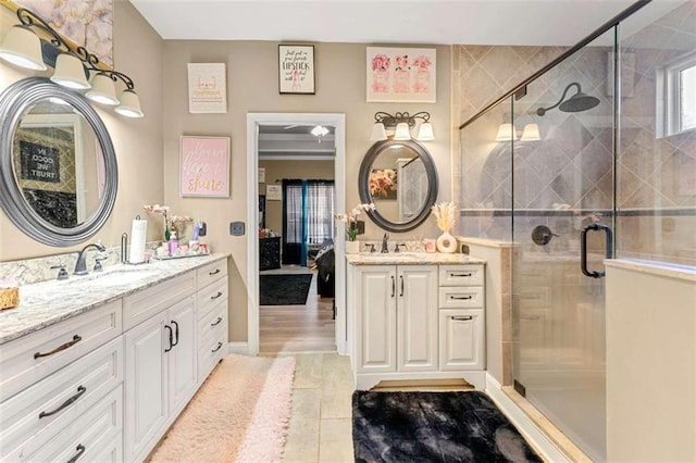 bathroom with vanity and a shower with door