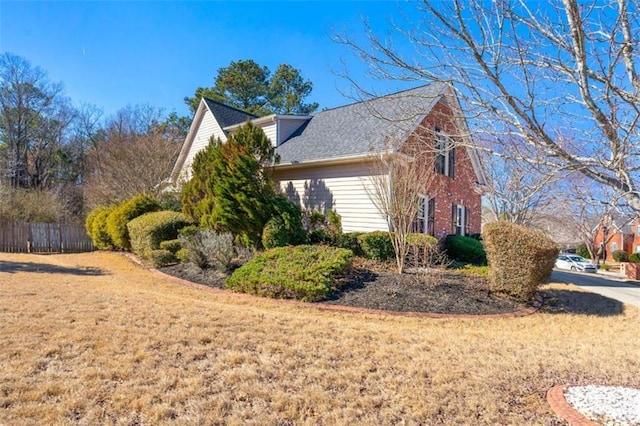 view of property exterior with a yard