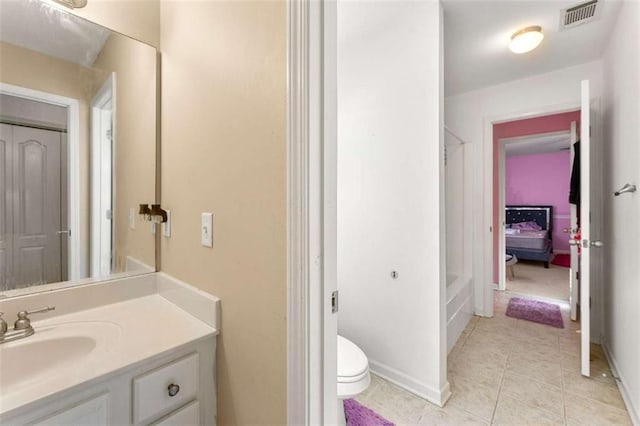 bathroom with vanity, toilet, and tile patterned flooring